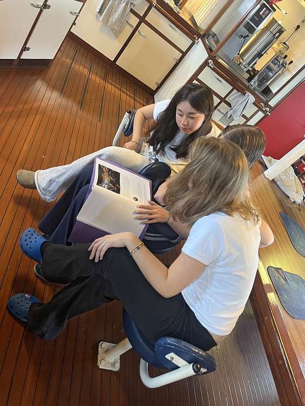 Liv, Maia und Carita lesen sich die letzten Blogbeiträge durch, die seit Neustem ausgedruckt werden